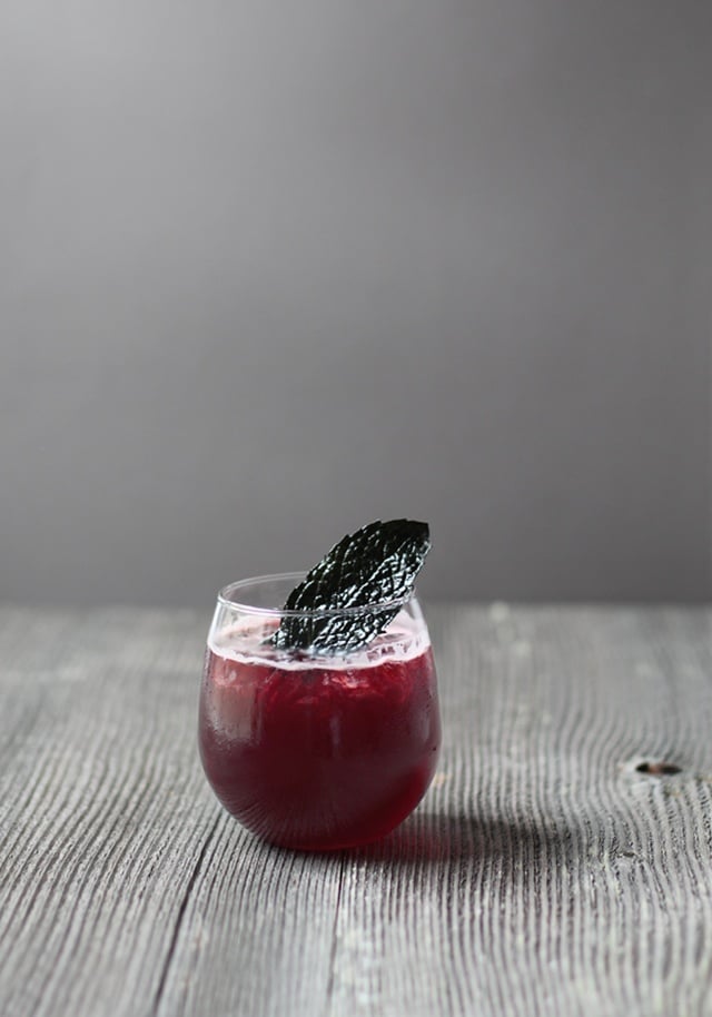 A spooky red and black Halloween cocktail in a glass. 