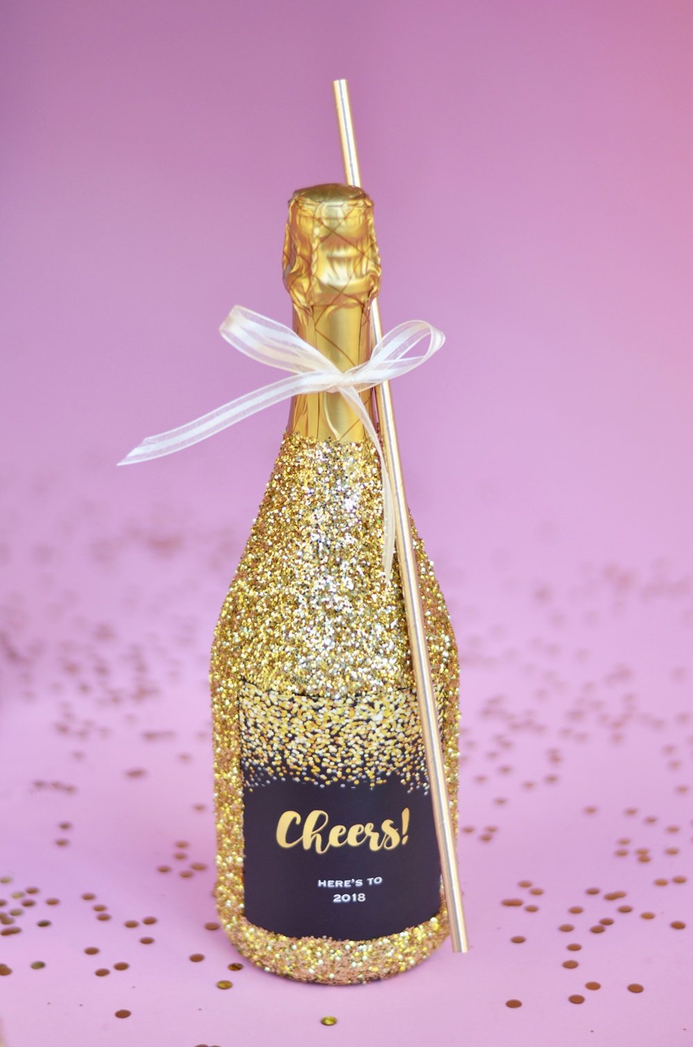 gold glitter champagne bottle with a giant bottle straw 