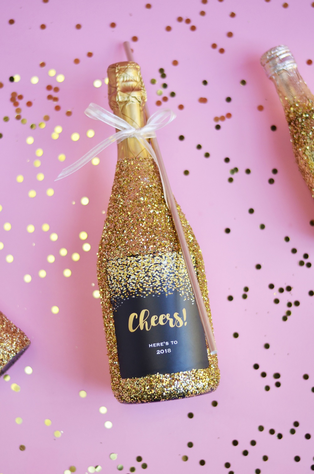 gold glitter champagne bottle with a giant bottle straw 